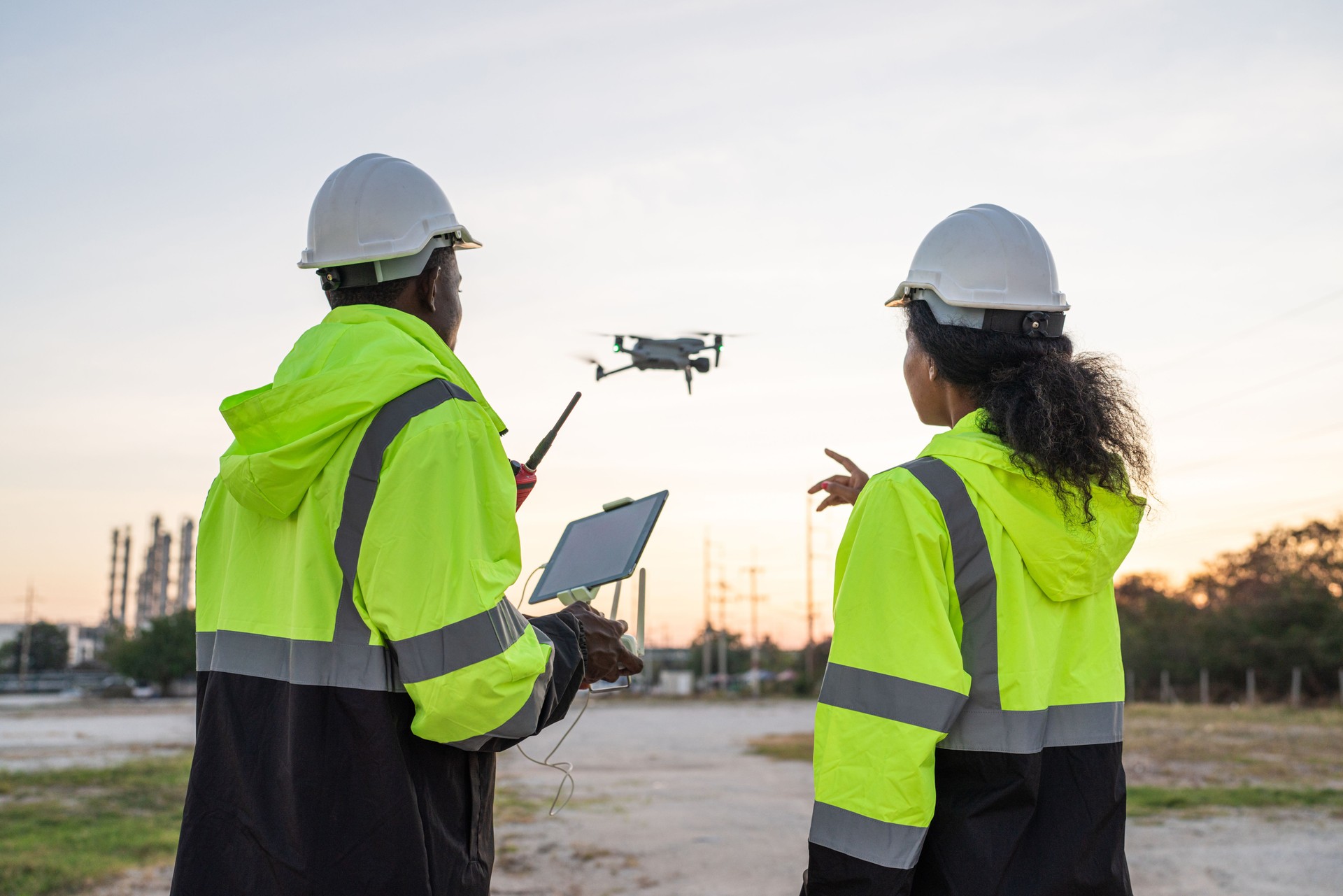 Team of Engineer Specialists Pilot Drone on Construction Site.