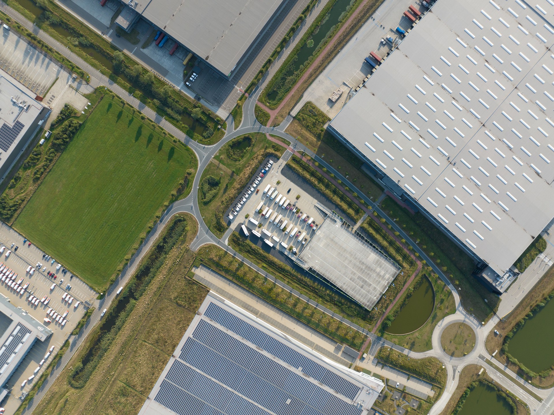 Aerial drone picture of modern distribution center in Venlo, The Netherlands. Solar panels on the roof, large warehouses.